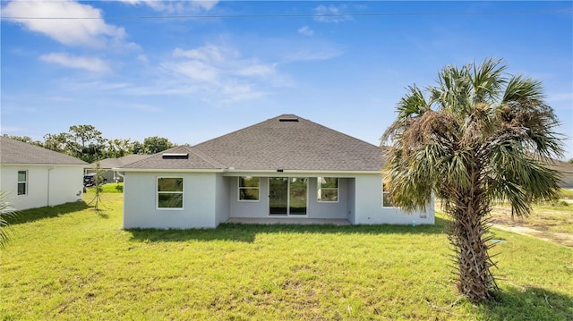 back of property featuring a lawn