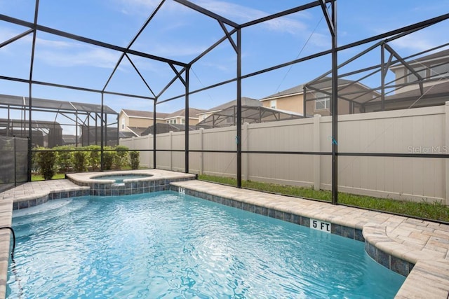 view of pool featuring glass enclosure and an in ground hot tub