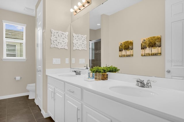 bathroom with tile patterned floors, vanity, toilet, and a shower with door