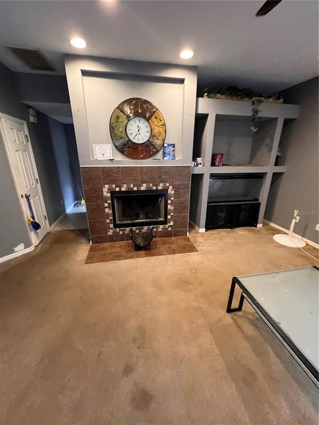 living room with a tile fireplace