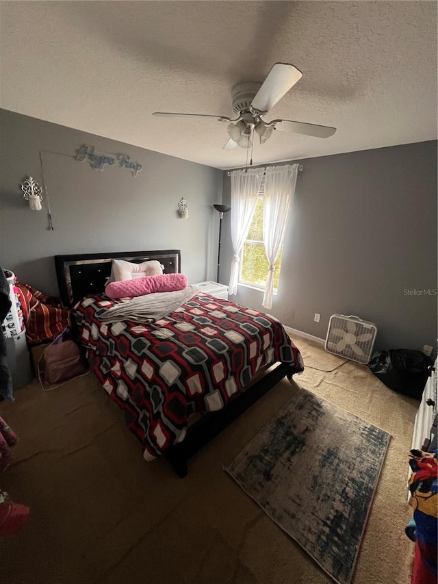 carpeted bedroom with a textured ceiling and ceiling fan