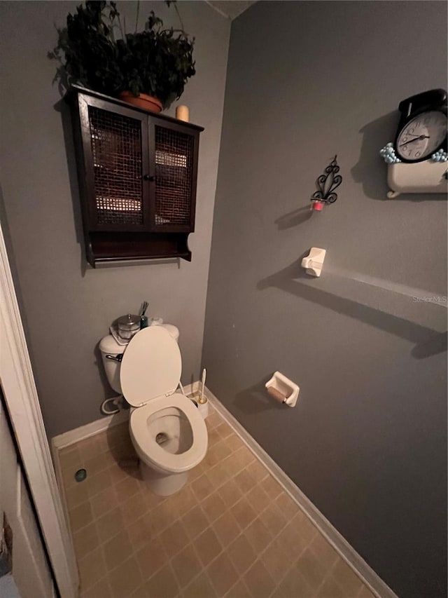 bathroom with tile patterned flooring and toilet