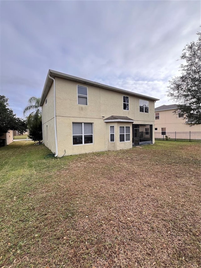 rear view of house with a yard