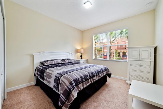 bedroom featuring light carpet