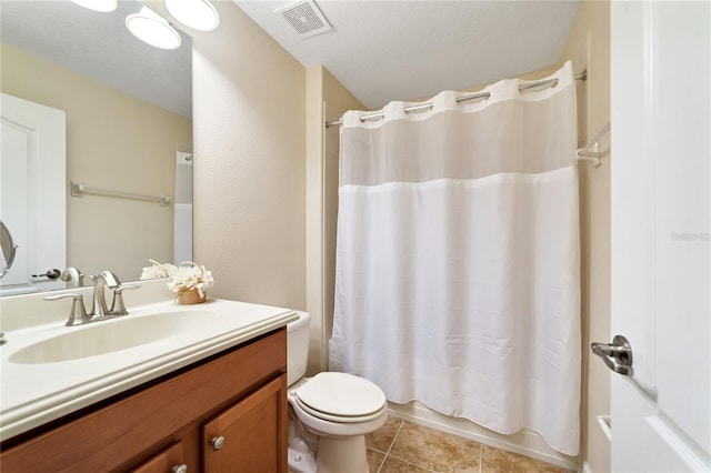 full bathroom featuring shower / tub combo, vanity, a textured ceiling, tile patterned flooring, and toilet