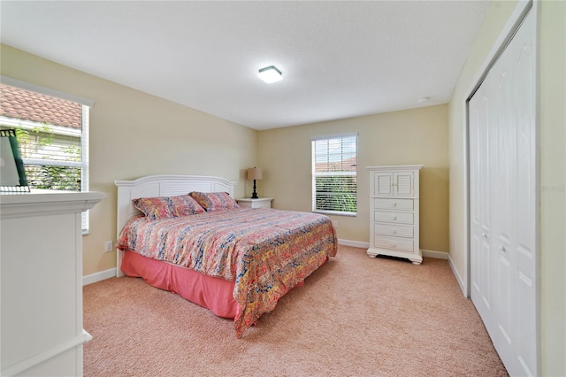 bedroom featuring carpet flooring and a closet