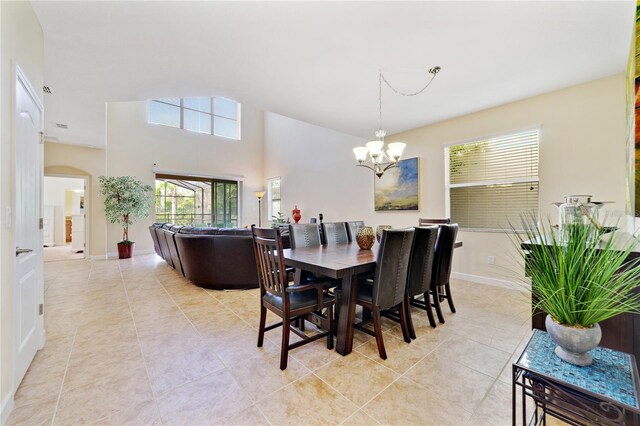 tiled dining space featuring a notable chandelier