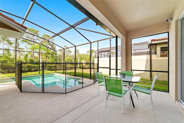 view of pool featuring glass enclosure and a patio area