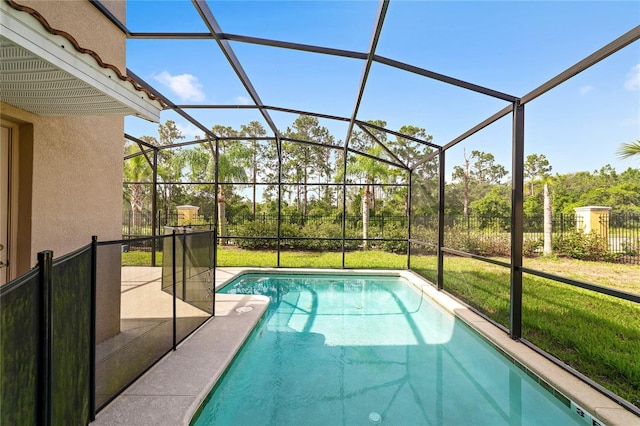 view of pool with a lanai and a lawn