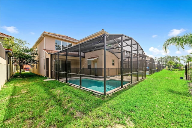 back of property featuring a lawn, glass enclosure, and a fenced in pool