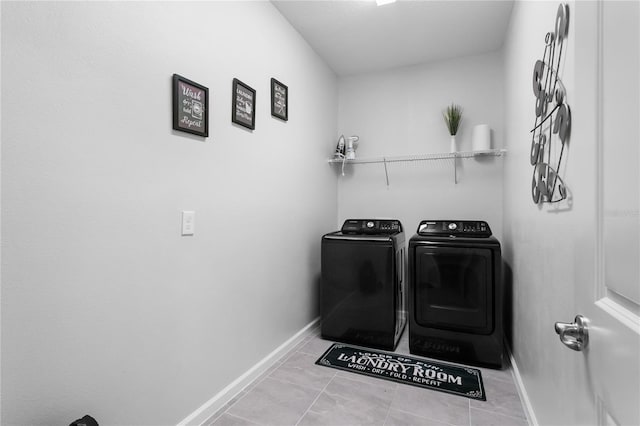 laundry room with separate washer and dryer and light tile patterned flooring