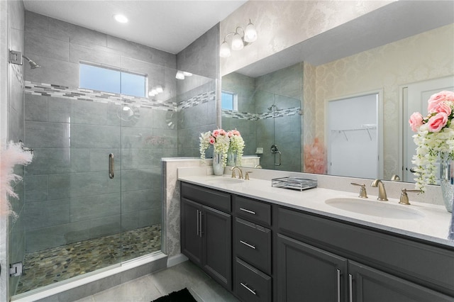 bathroom with vanity, a shower with door, and tile patterned flooring