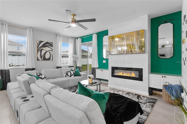 tiled living room featuring ceiling fan