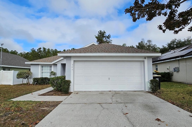 ranch-style house featuring a front yard and a garage