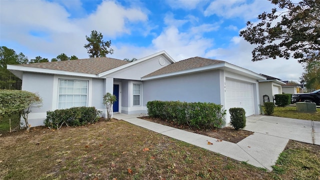 single story home featuring a garage and a front yard