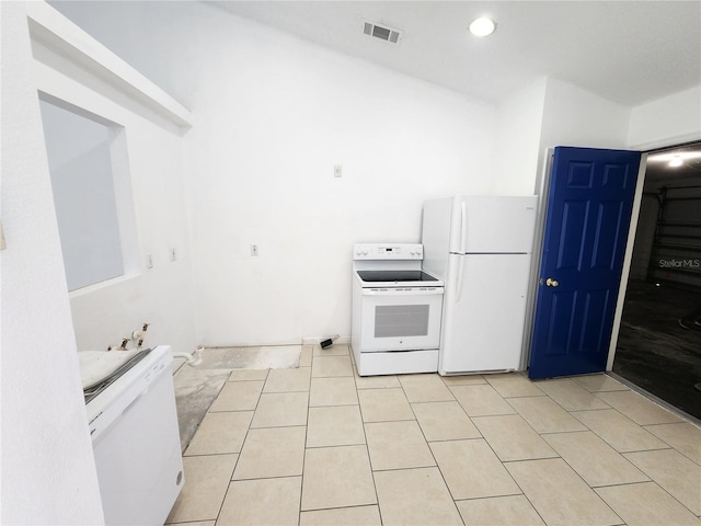 kitchen featuring light tile patterned flooring and white appliances