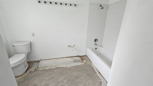 bathroom featuring toilet, tiled shower / bath, and concrete floors