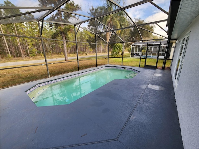 view of pool featuring a patio and glass enclosure