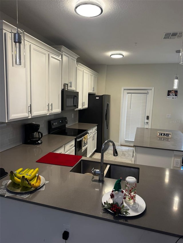 kitchen with black appliances, backsplash, white cabinetry, and hanging light fixtures