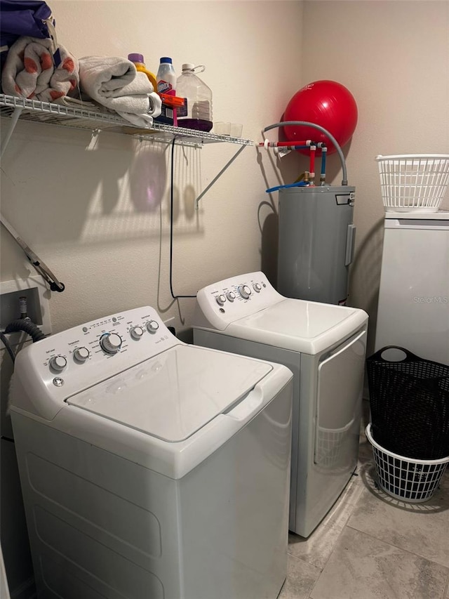 laundry area with washer and dryer and electric water heater