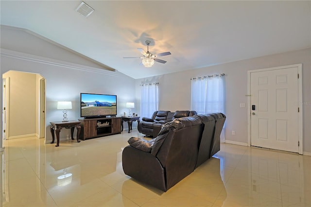 tiled living room with ceiling fan and lofted ceiling