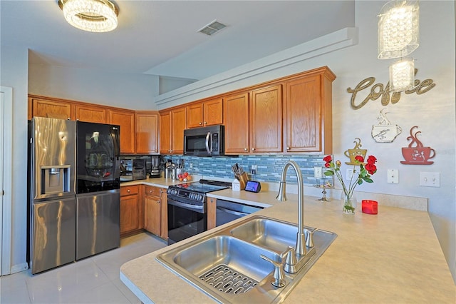 kitchen featuring backsplash, black appliances, sink, hanging light fixtures, and light tile patterned flooring