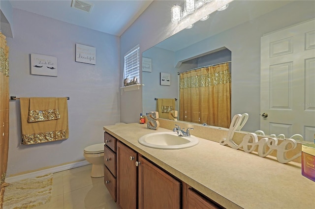 bathroom featuring tile patterned flooring, vanity, and toilet