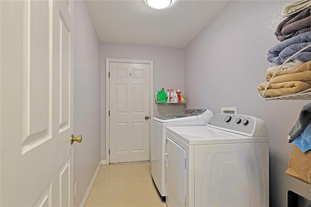 washroom featuring separate washer and dryer and light tile patterned floors