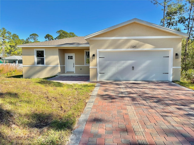 ranch-style home with a garage and a front yard