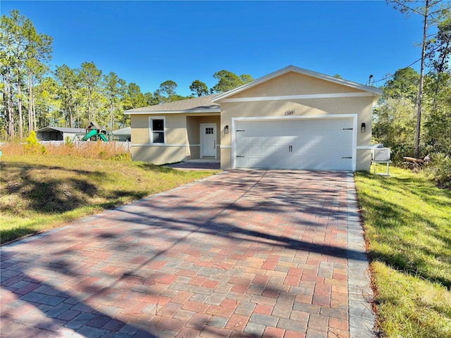 ranch-style home with a garage, a front lawn, and cooling unit