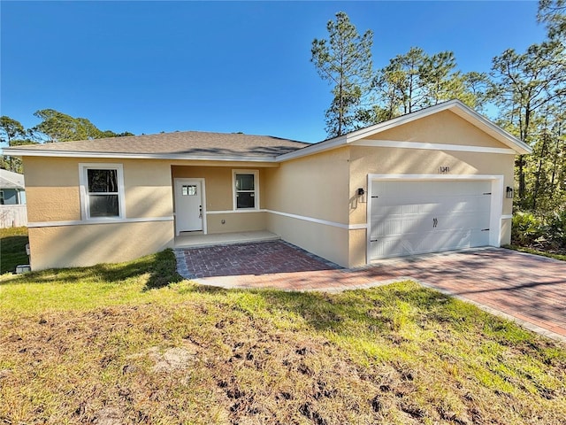 single story home featuring a front yard and a garage