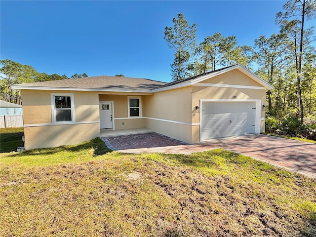 ranch-style home with a front yard and a garage