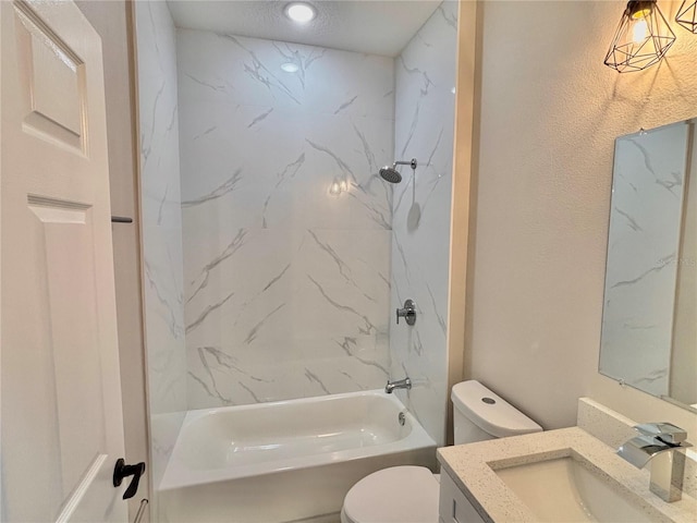 full bathroom featuring vanity, tiled shower / bath combo, and toilet