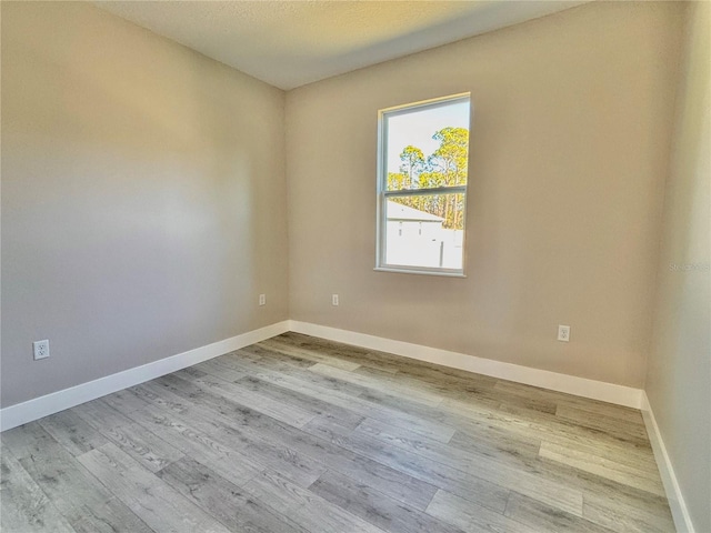 unfurnished room with light hardwood / wood-style floors