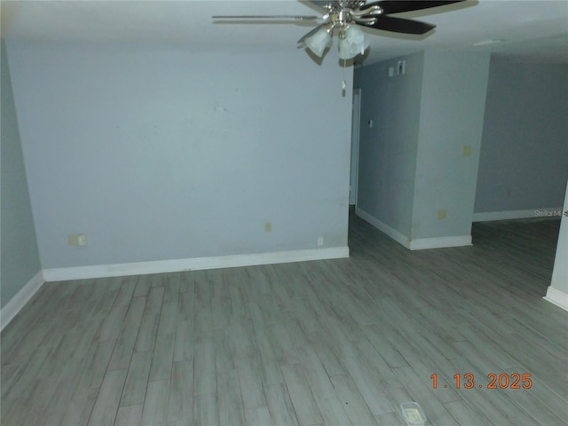 spare room featuring light wood-type flooring and ceiling fan