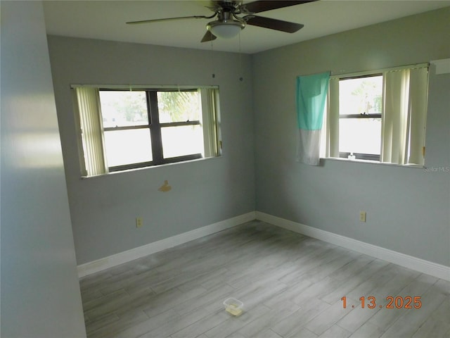 spare room featuring light hardwood / wood-style floors and ceiling fan