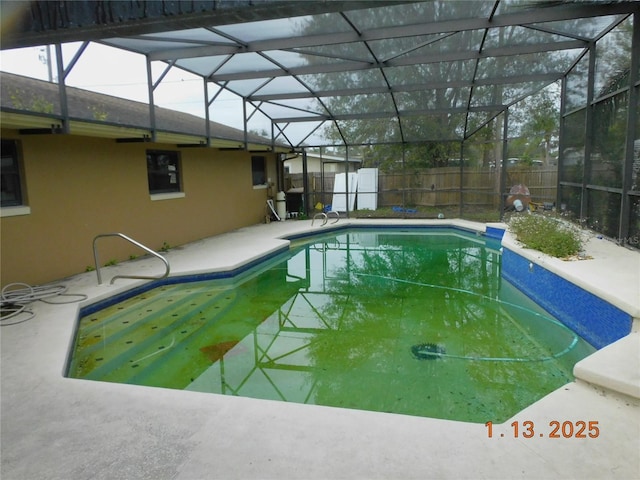 view of pool with a lanai and a patio