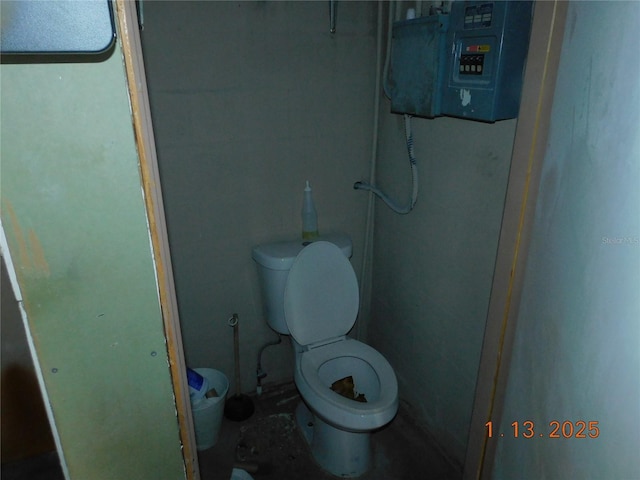 bathroom featuring toilet and electric panel