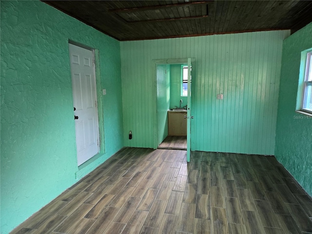 spare room featuring wooden ceiling and dark wood-type flooring