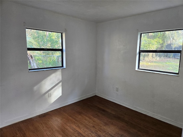 spare room with dark hardwood / wood-style floors