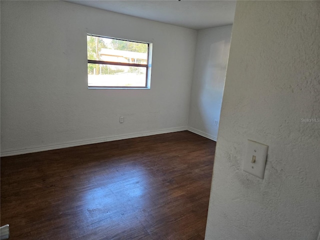 unfurnished room featuring dark hardwood / wood-style flooring