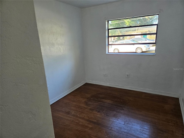 empty room featuring dark hardwood / wood-style flooring