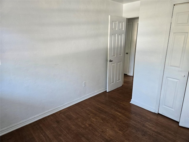 unfurnished bedroom featuring dark wood-type flooring