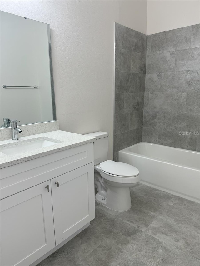 full bathroom with shower / washtub combination, vanity, and toilet