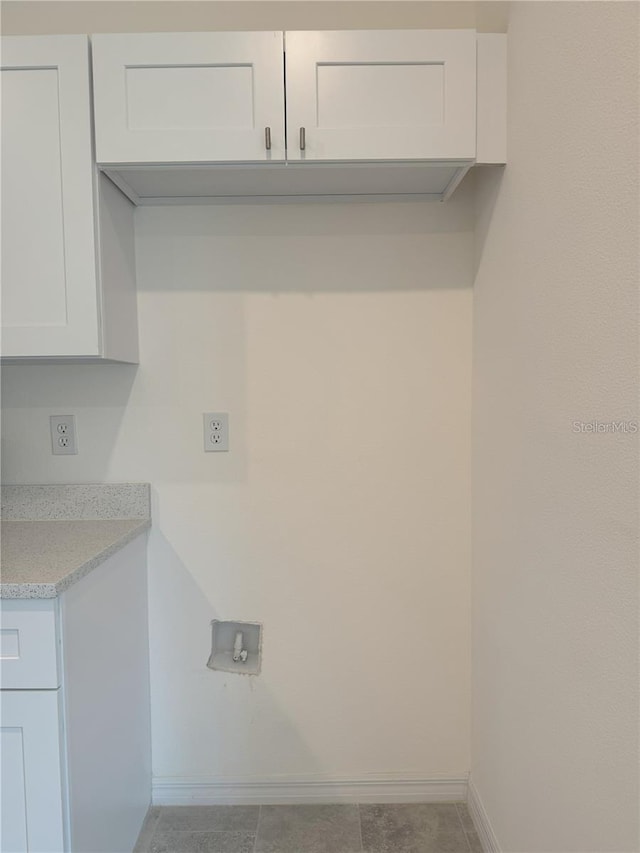 washroom with cabinets and hookup for a washing machine