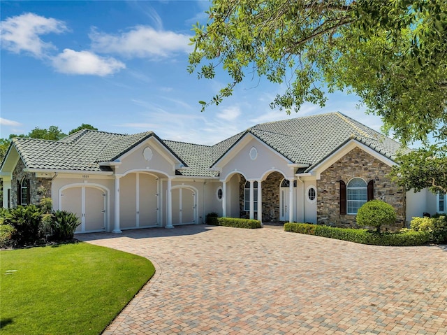 view of front of property featuring a garage and a front lawn