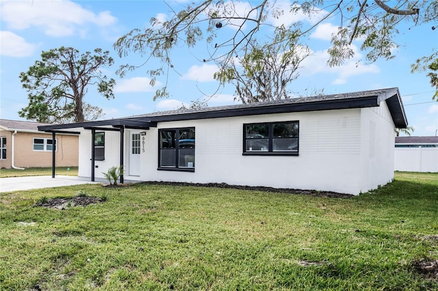 ranch-style home with a front lawn