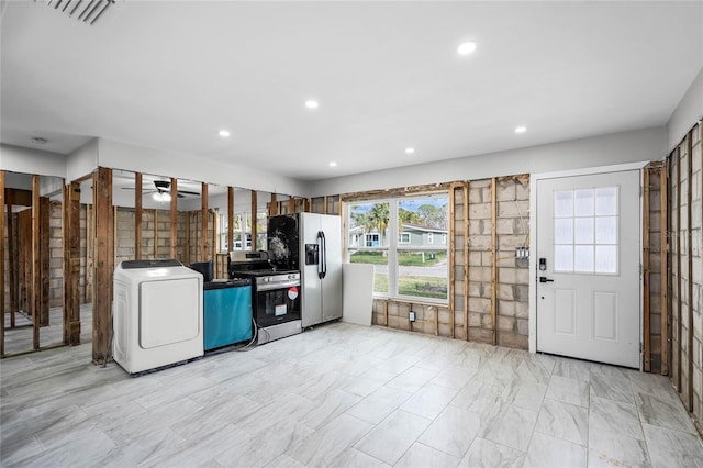 kitchen with appliances with stainless steel finishes, ceiling fan, and washer / clothes dryer