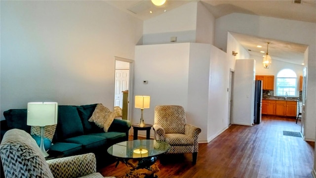 living room with high vaulted ceiling, ceiling fan, dark hardwood / wood-style floors, and sink