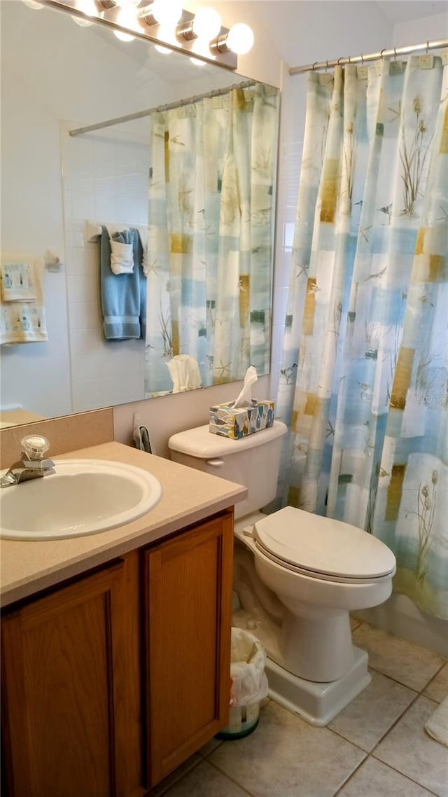 bathroom with toilet, vanity, a shower with shower curtain, and tile patterned flooring